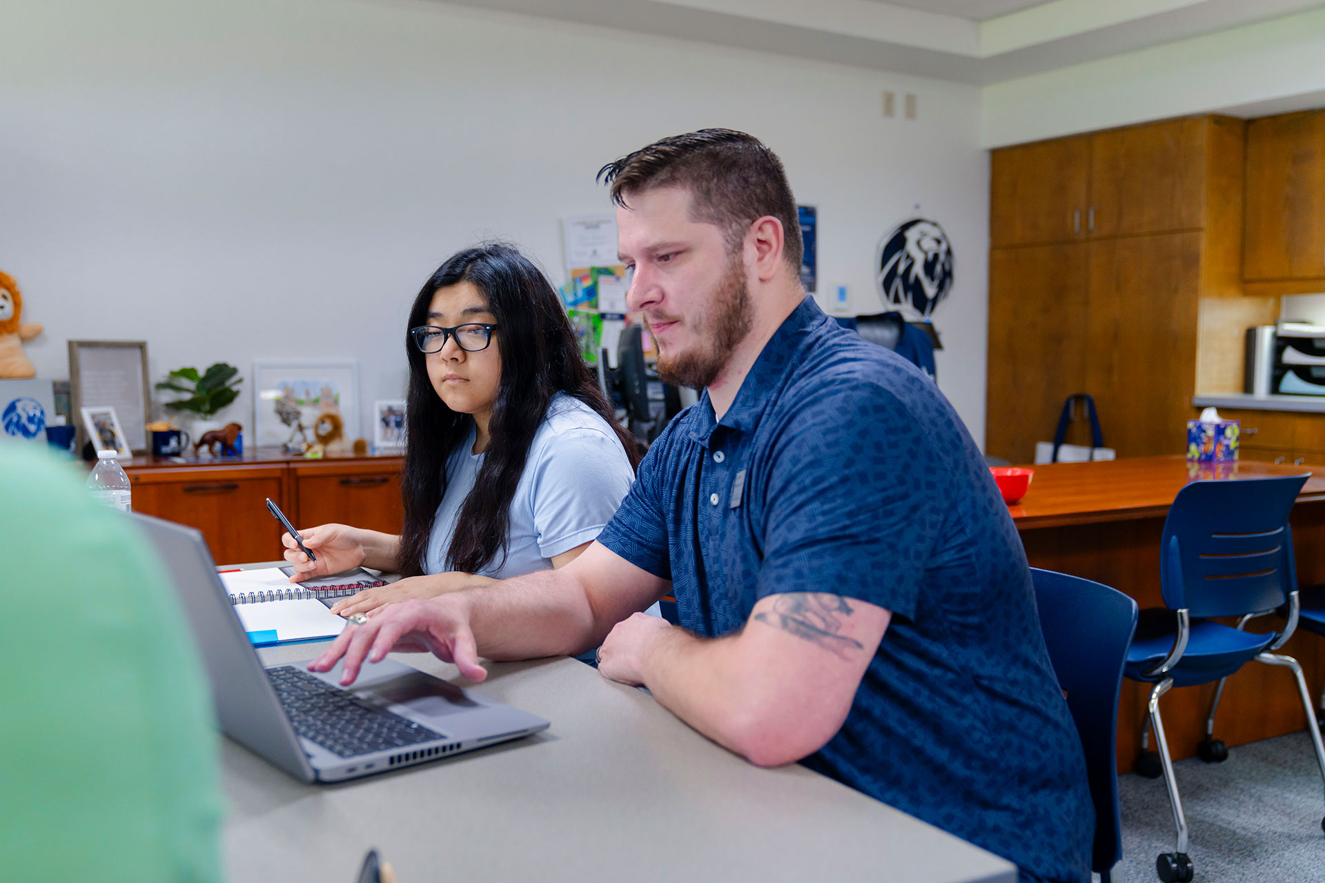SDS staff working with a student at a laptop
