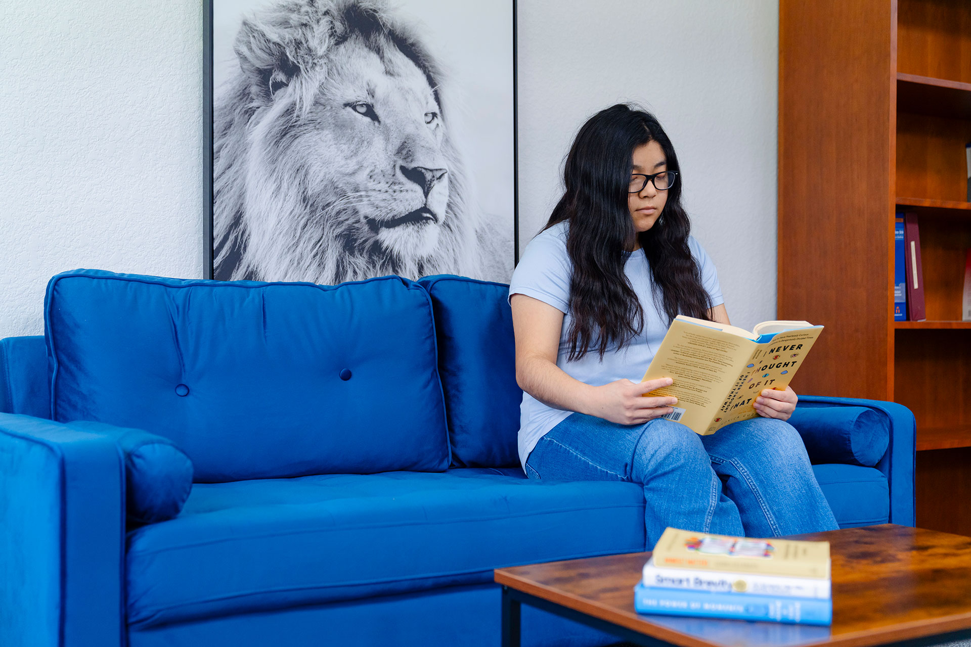 Student reading a book in the SDS office