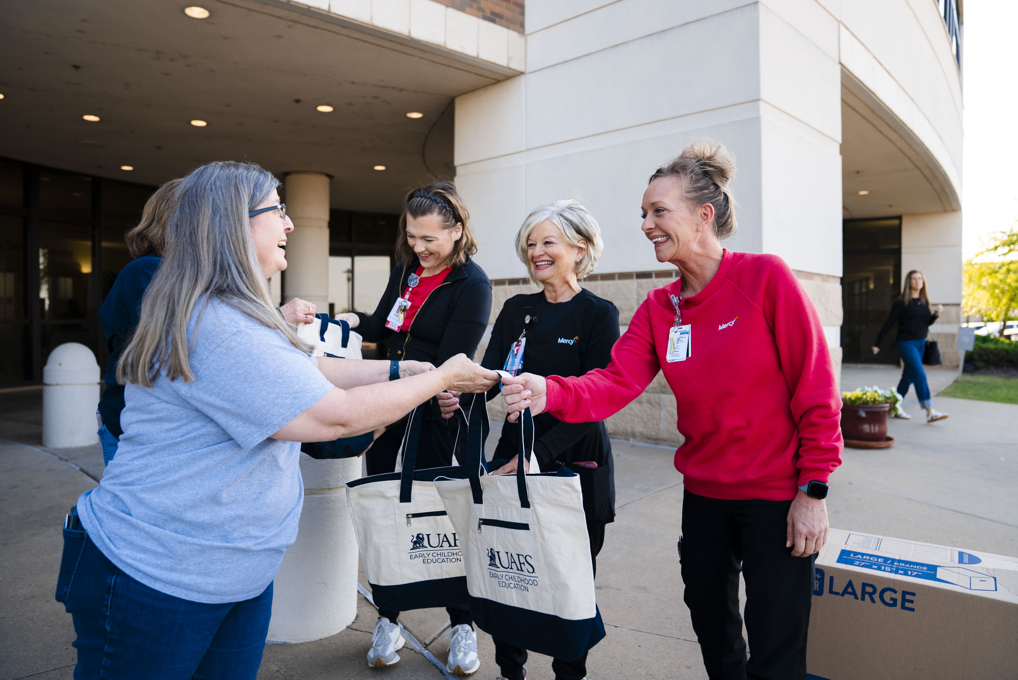 lady handing a bag to a group of other ladies