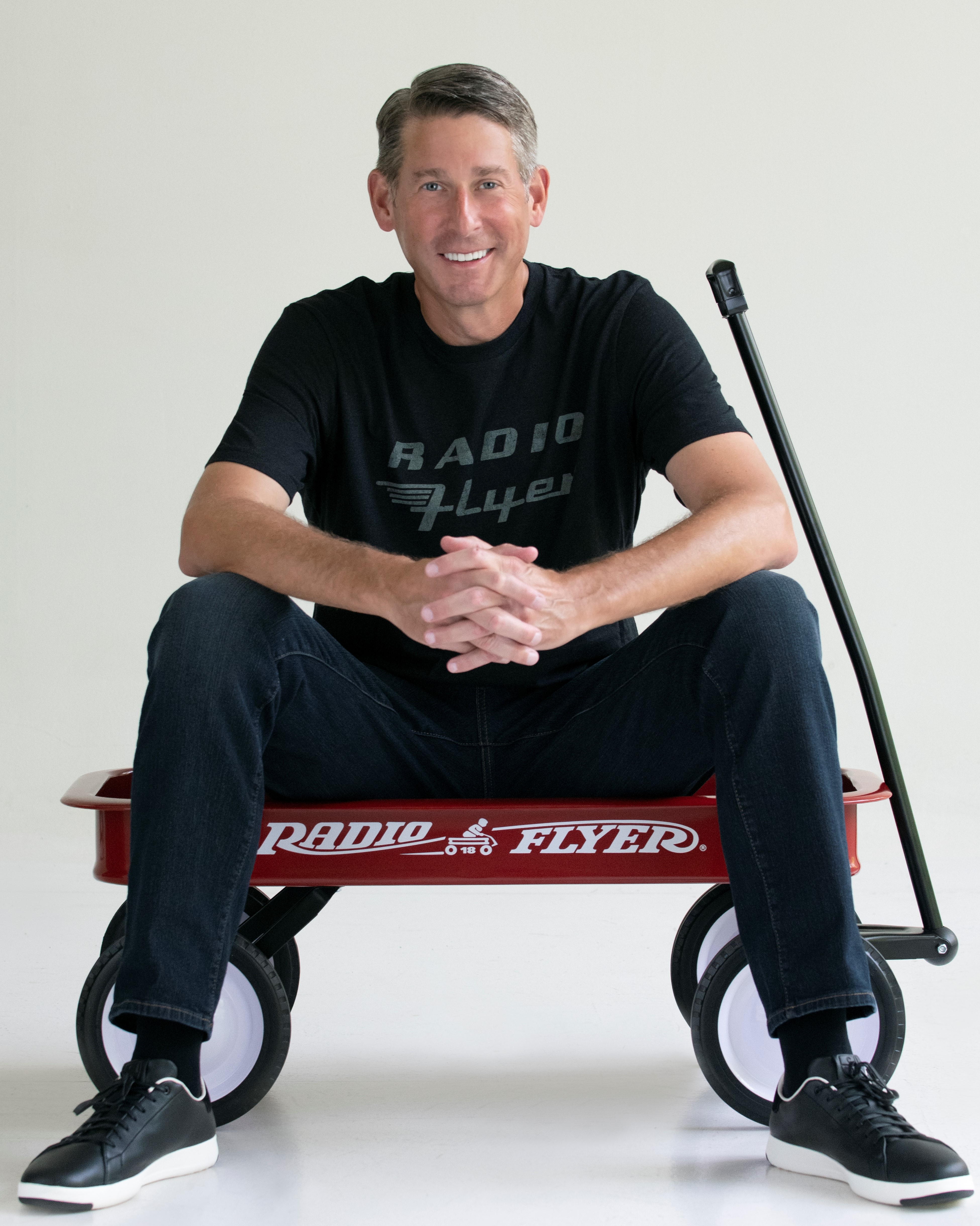 Robert Pasin in a little red wagon