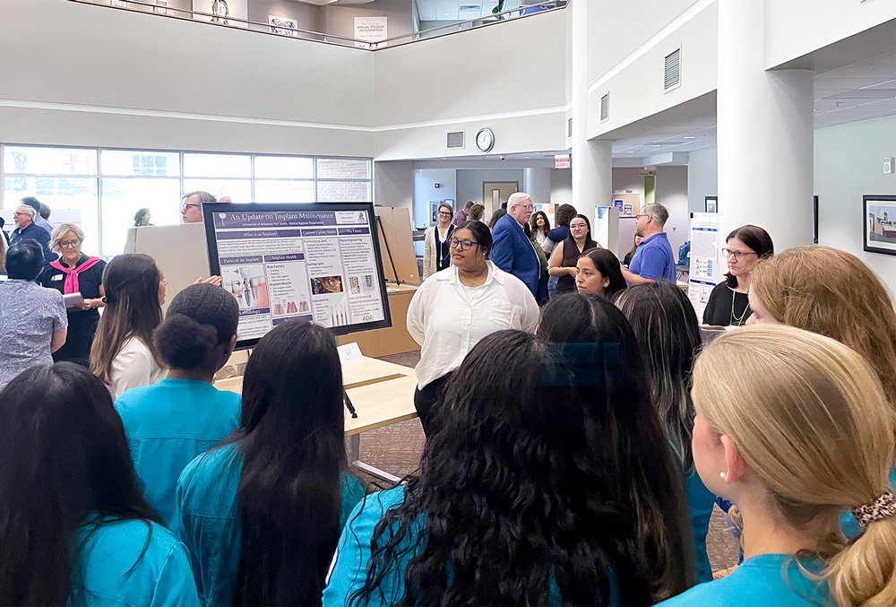 The team of Brenci Marrufo, Mesa Miller, and Erica Mimbs present their research project,
