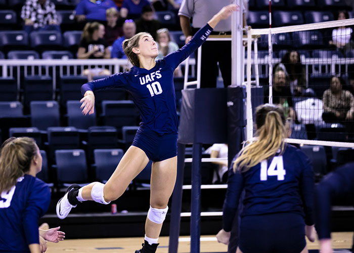 Anna Demmer (10) leaps to return a shot by an opponent