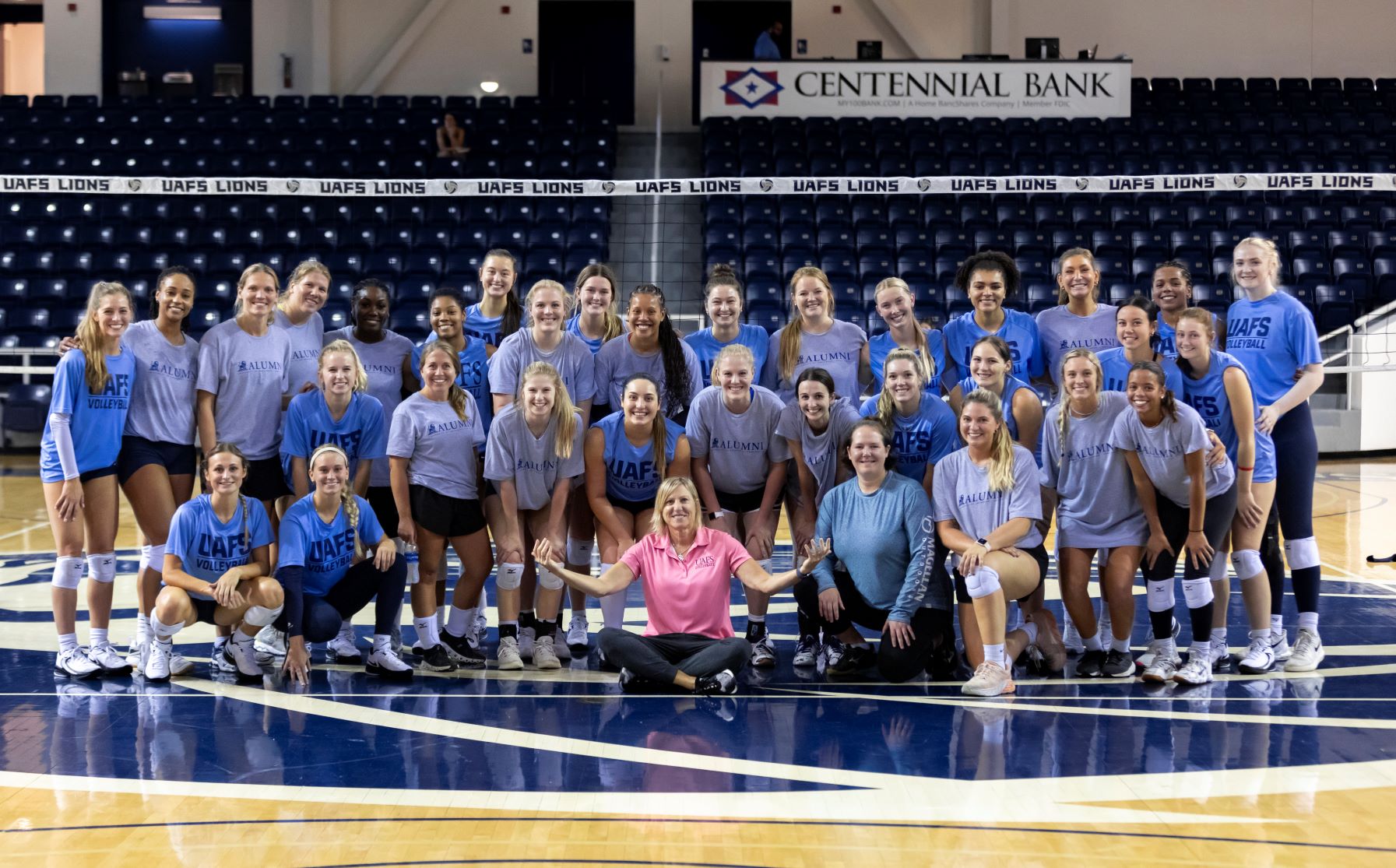 Alumni and current volleyball players with coach Jane Sargent