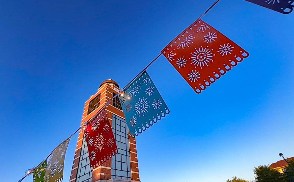 Hispanic Heritage Month, flags in the foreground, UAFS Belltower in the background