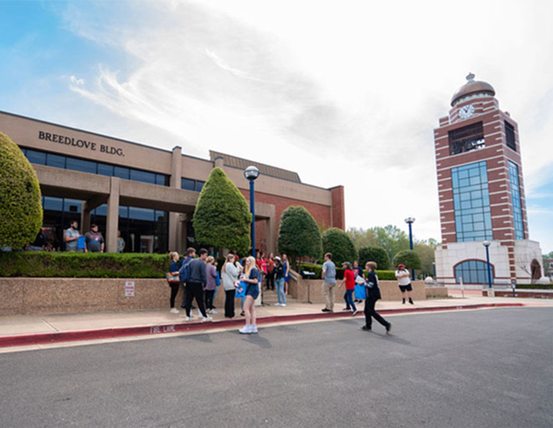 UAFS students outside walk to class and gather outside of the Breedlove Building and UAFS Bell Tower