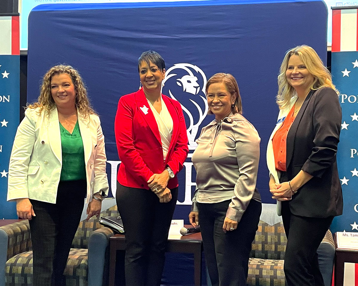 Panelists from Women in Charge pose after event