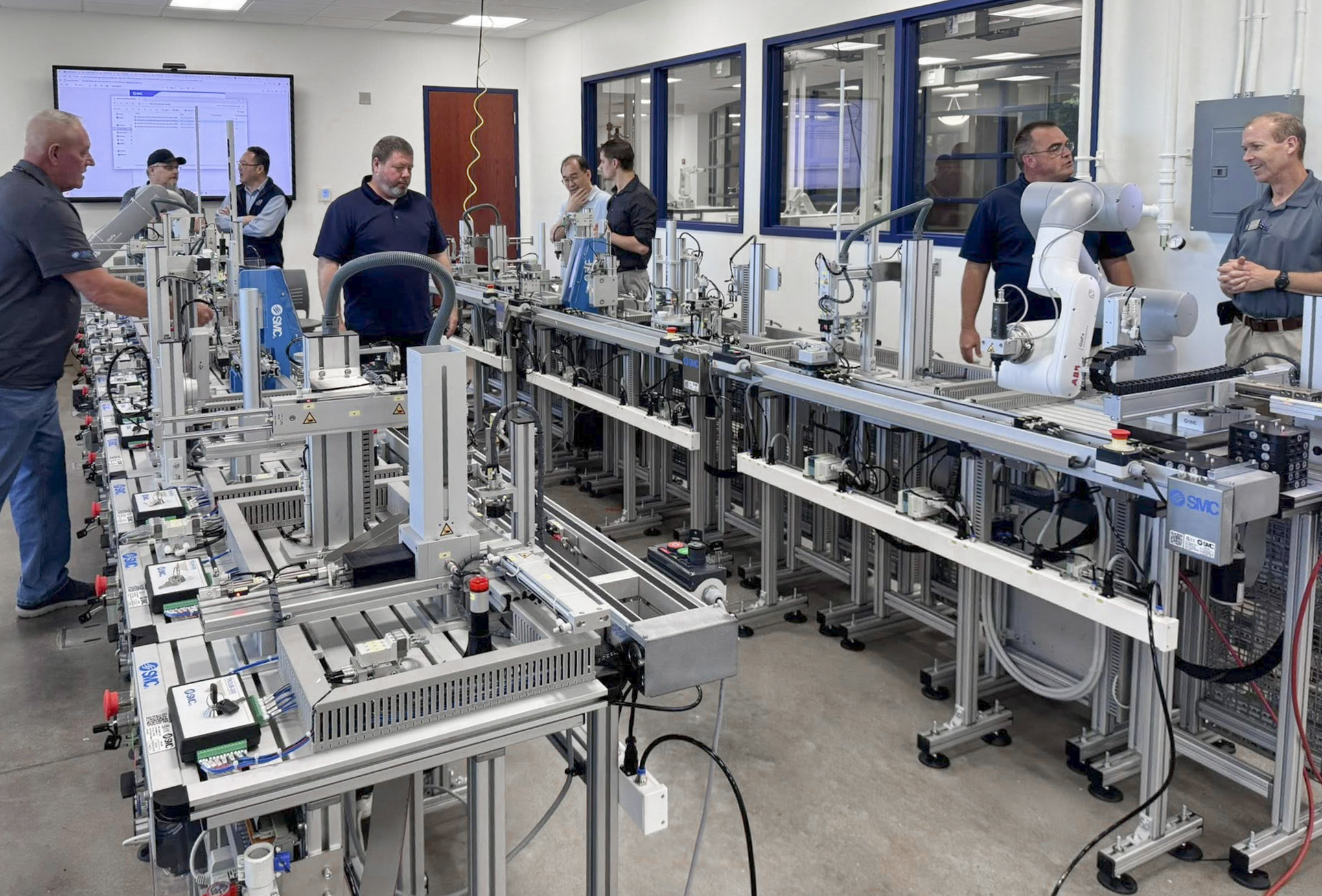 Faculty of the UAFS college of business and industry tour a lab with new advanced manufacturing engineering equipment