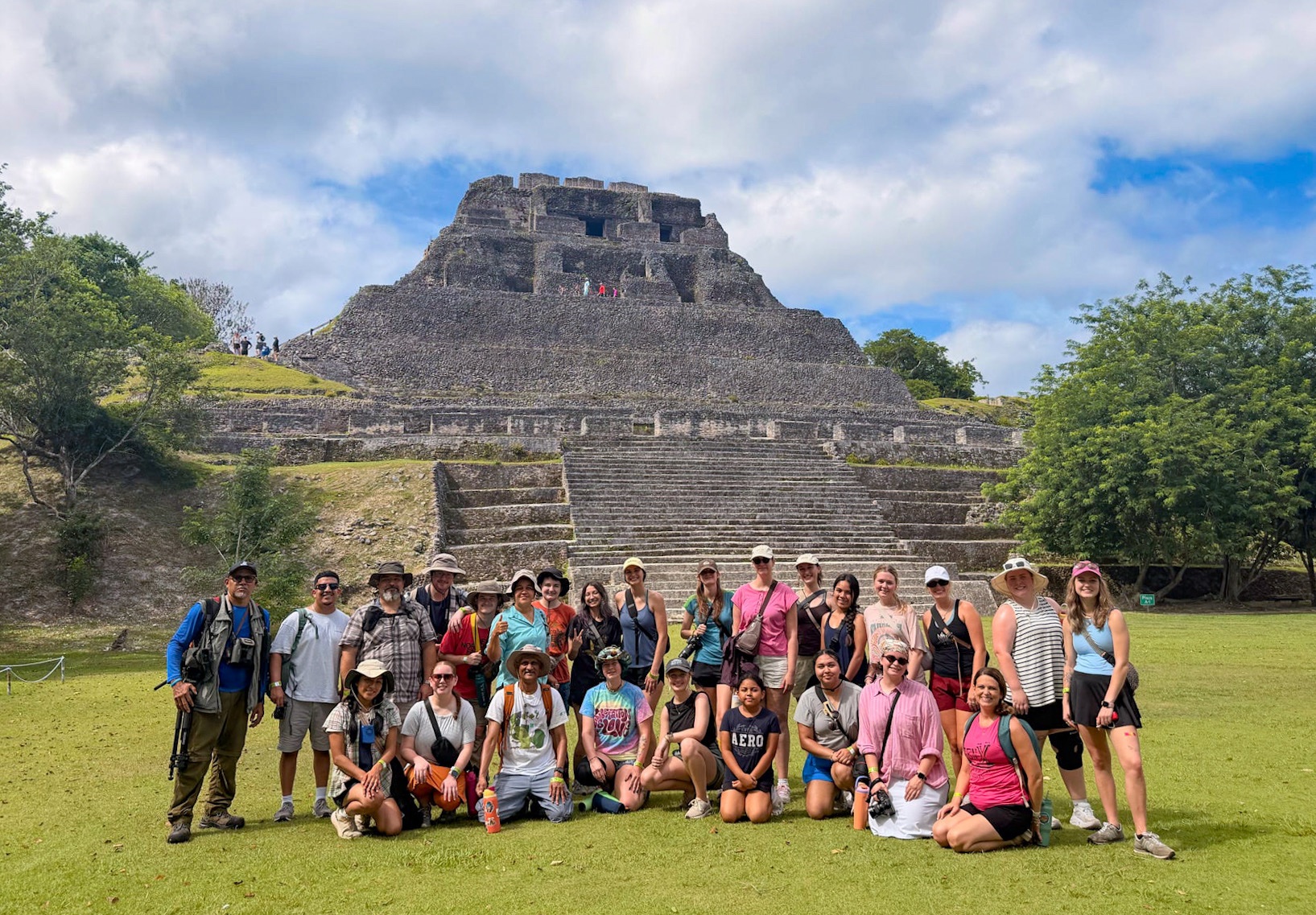 group of students posing in front of a Mayan pyramide in Belize