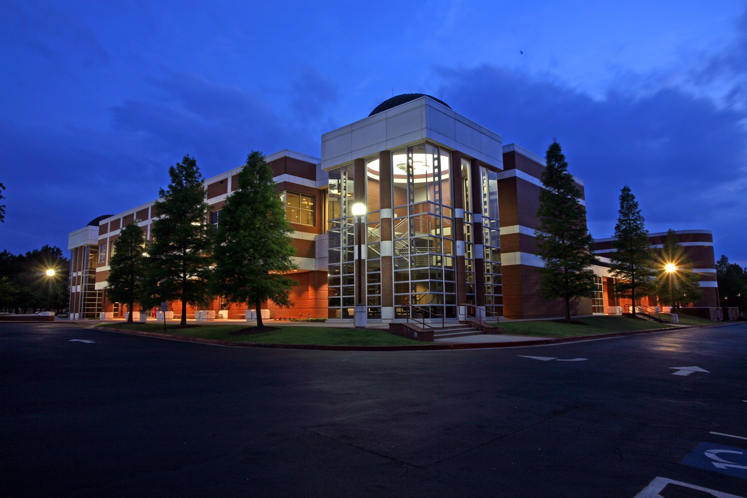 An evening photo of the Smith-Pendergraft Campus Center