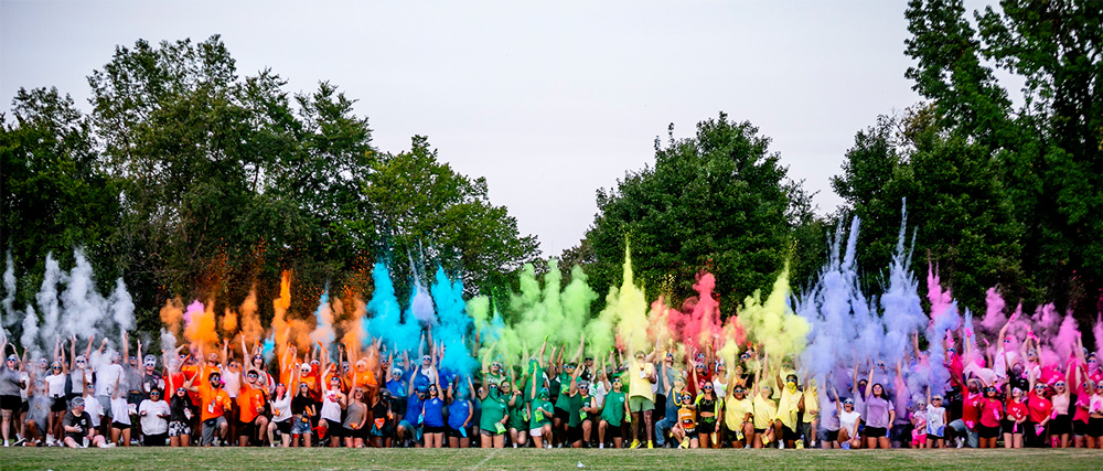 Cub Camp teams throw their camp colors in the air at the color war