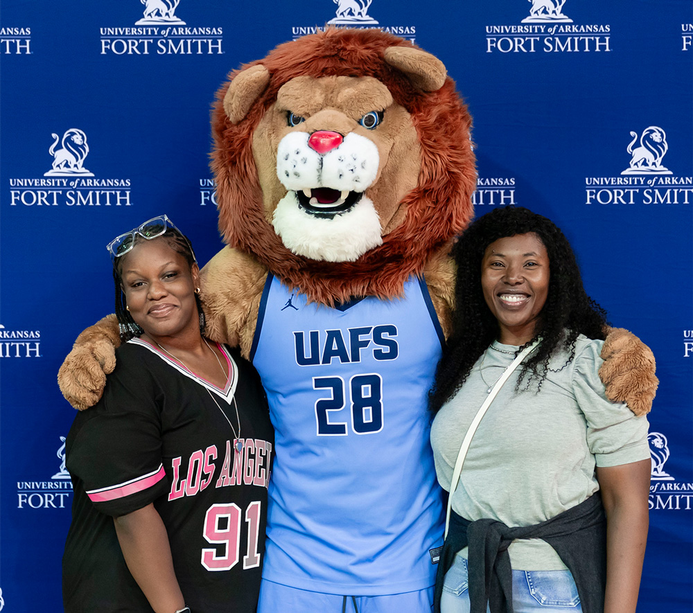 Eden Paul (left) and her mom, Sasha Hemmings, smile with Numa at the 2026 Spring Den Day. Eden and her mom are from Nassau, Bahamas, and Eden is planning to study imaging sciences.