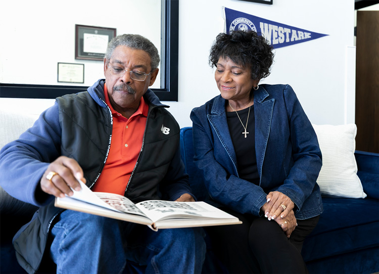 Fanny Wesley and her husband Robert look at a Numa, the UAFS yearbook, in the UAFS Alumni Office.