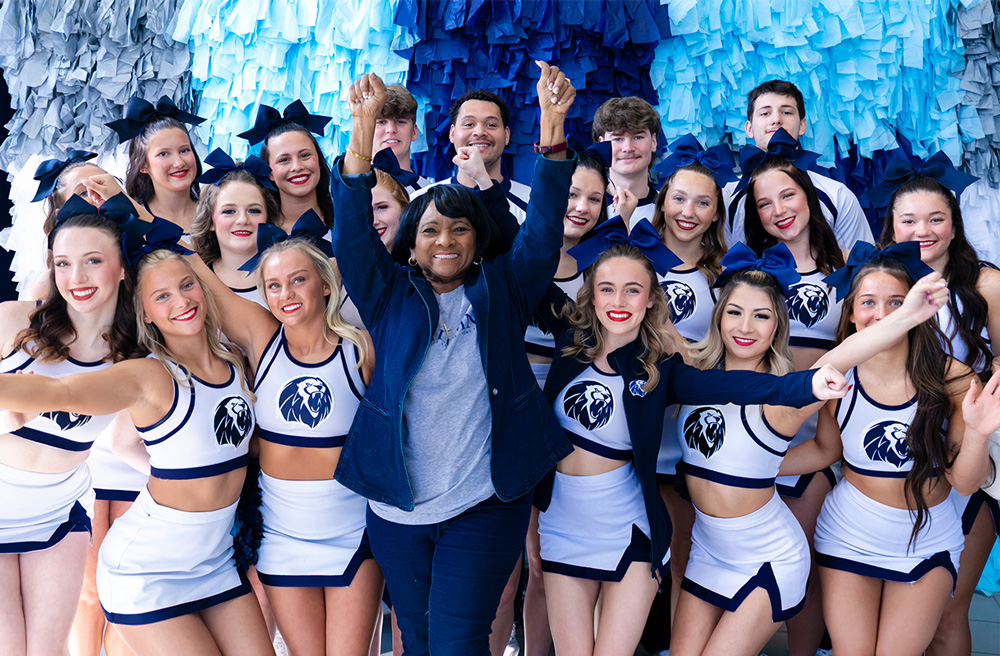 Fanny Wesley, center, was the first Black cheerleader at UAFS. At the 2026 Homecoming, she posed with the current UAFS Cheer team.