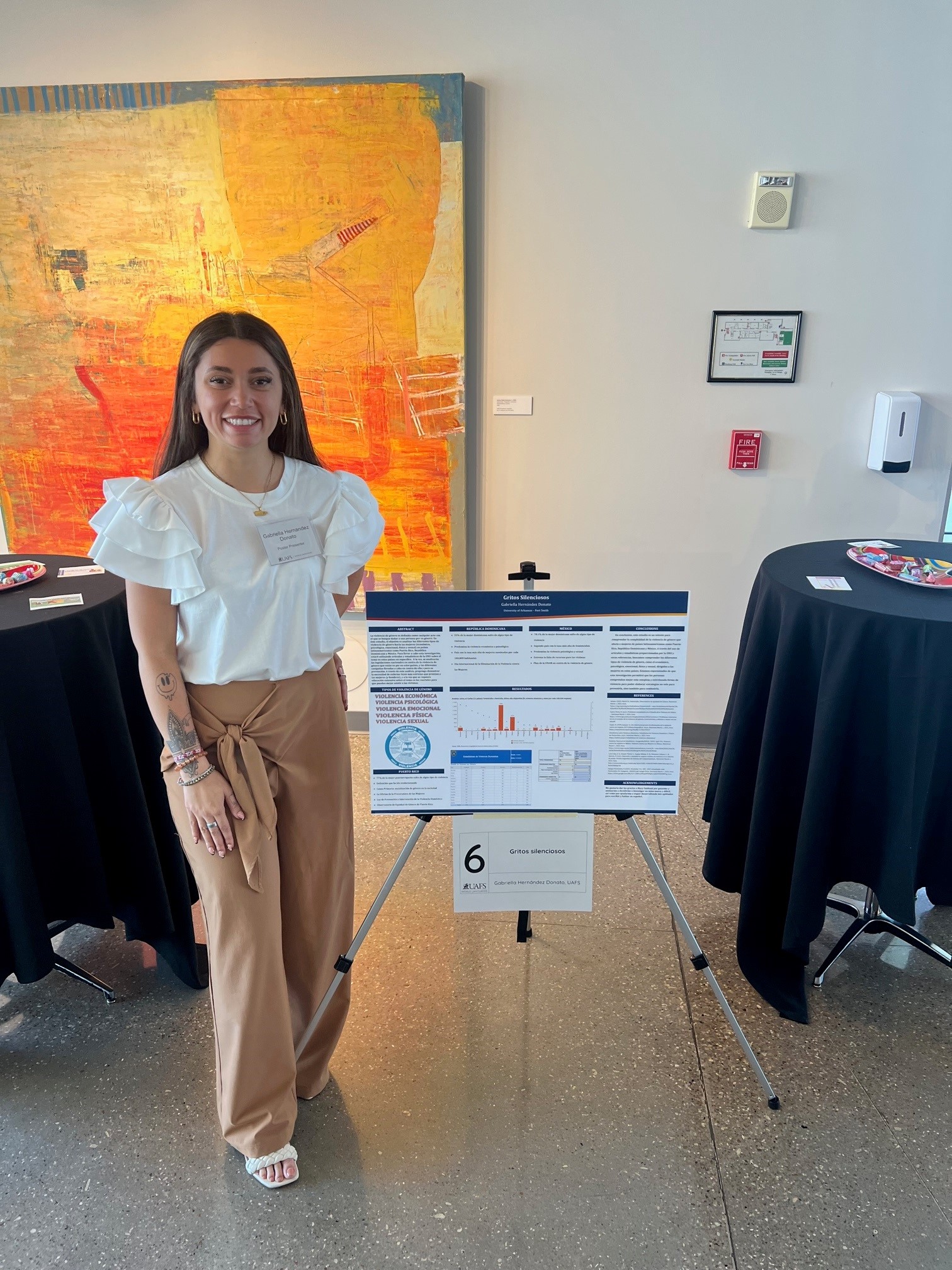 Young woman next to a poster