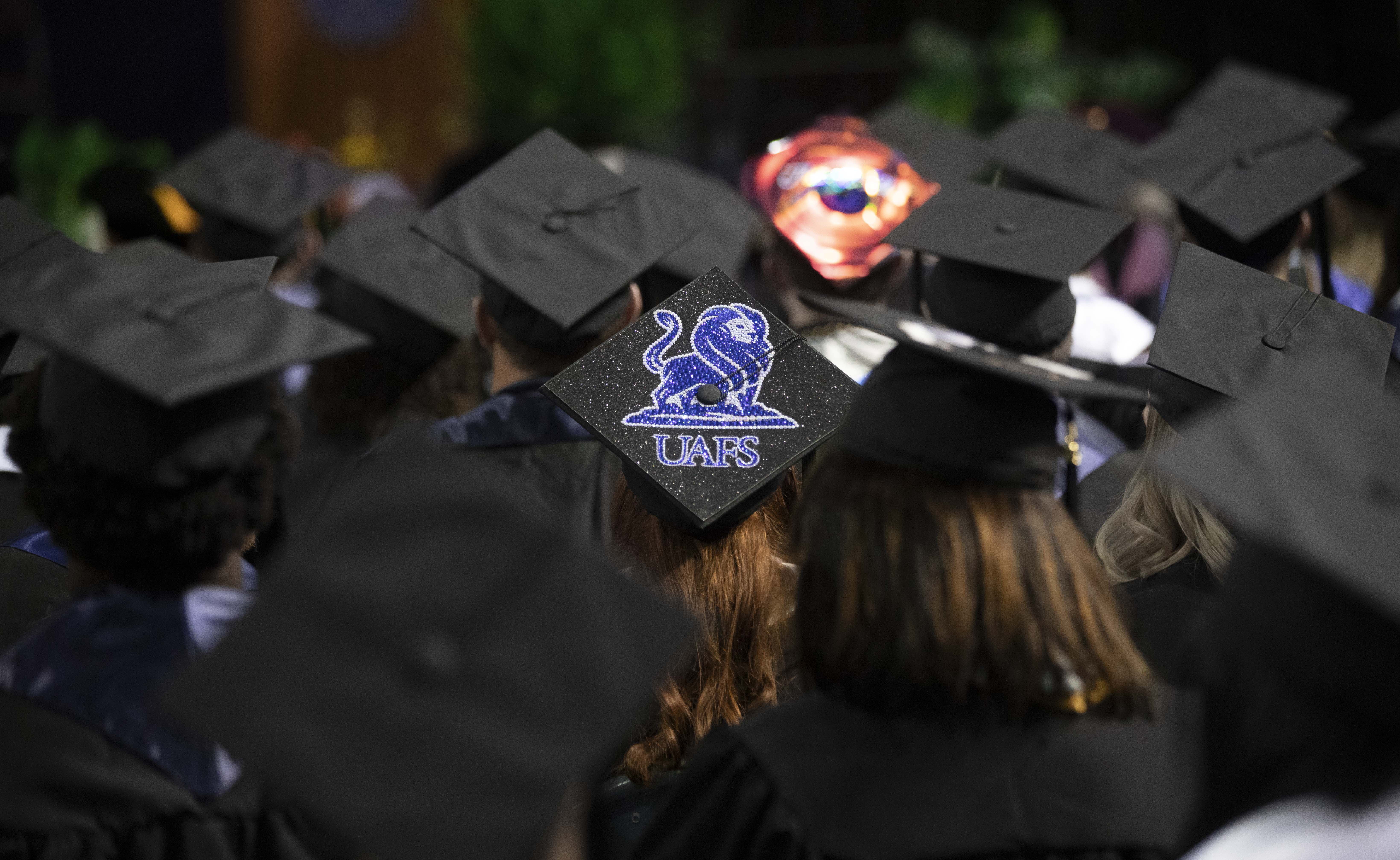 grad caps feature the UAFS logo