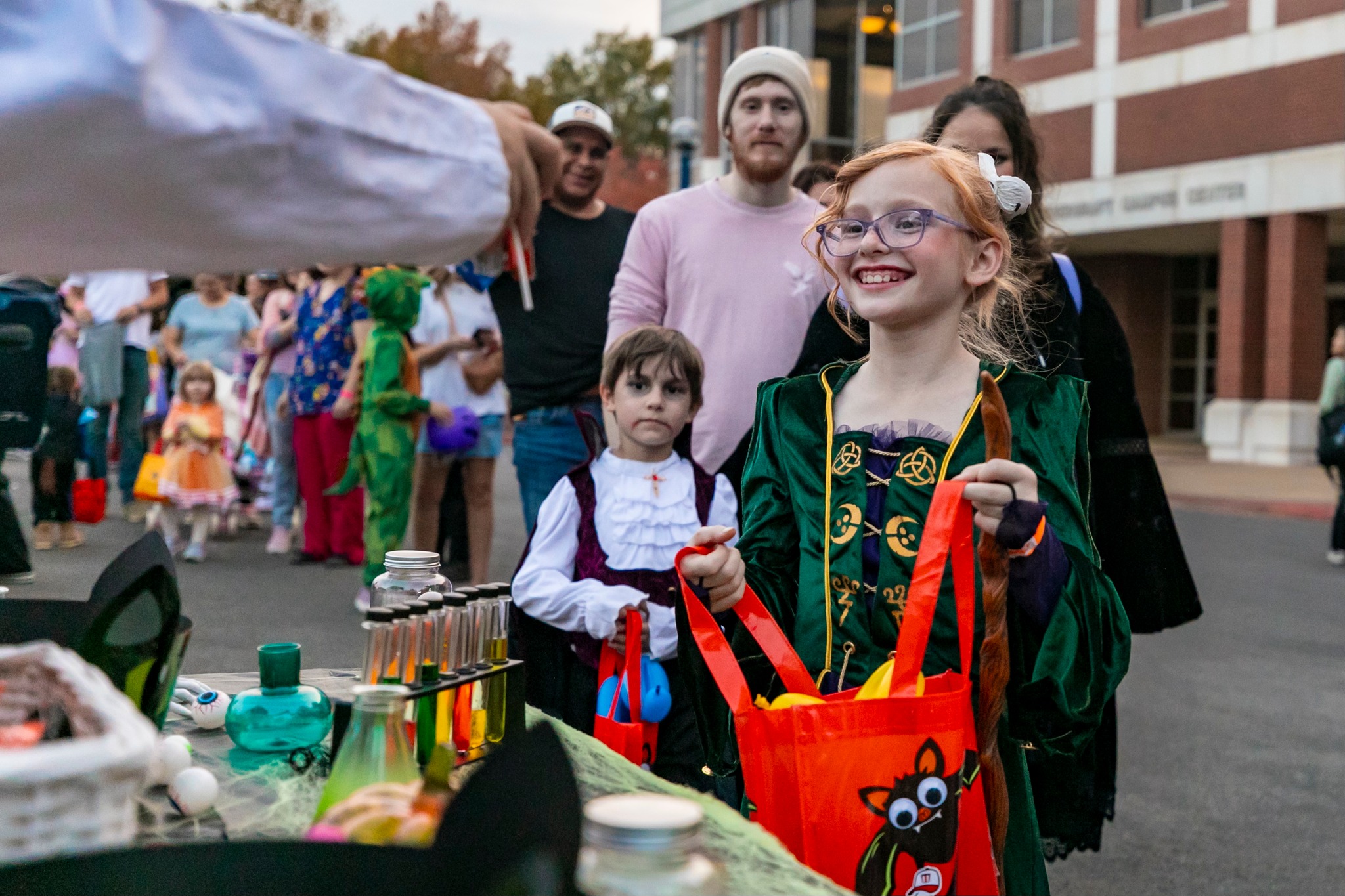UAFS students give away candy during trunk-or-treat at Haunted University.