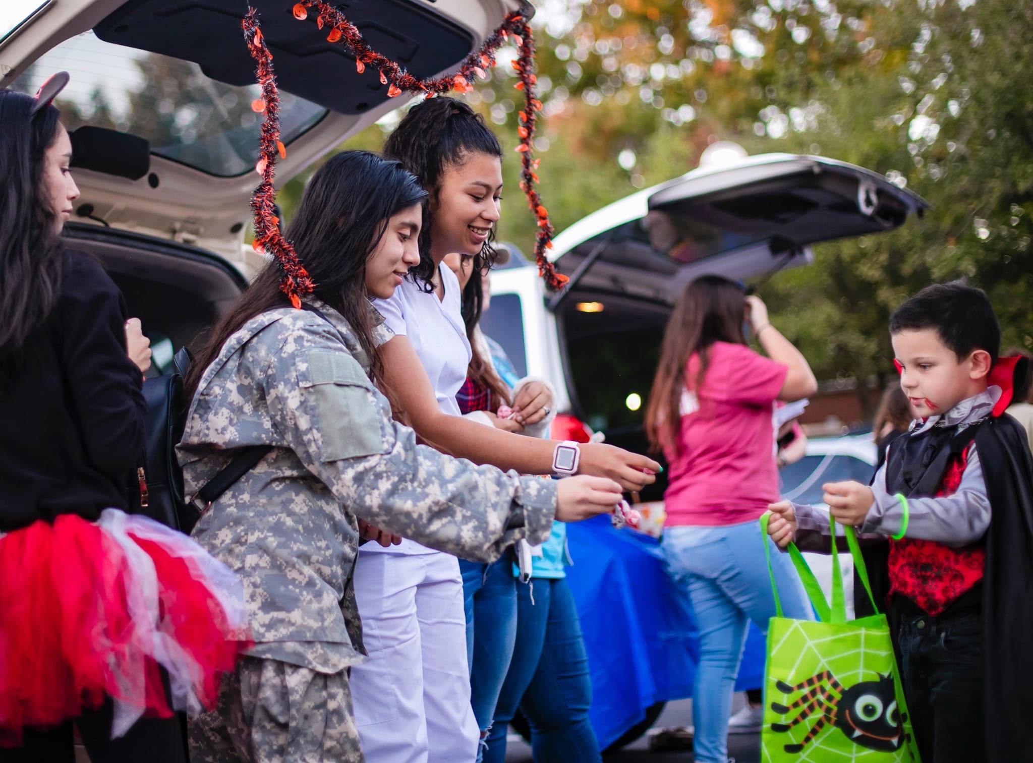 UAFS students give away candy during trunk-or-treat at Haunted University.