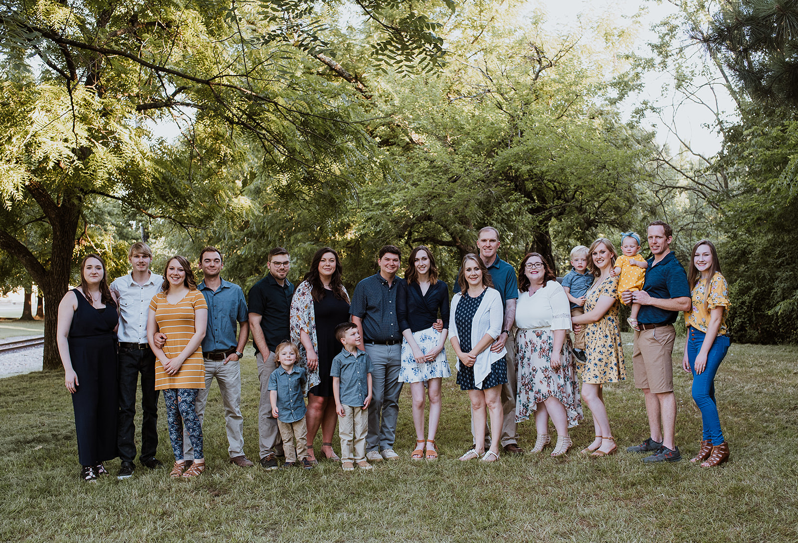 Hannah and her family pose for a photo under trees 