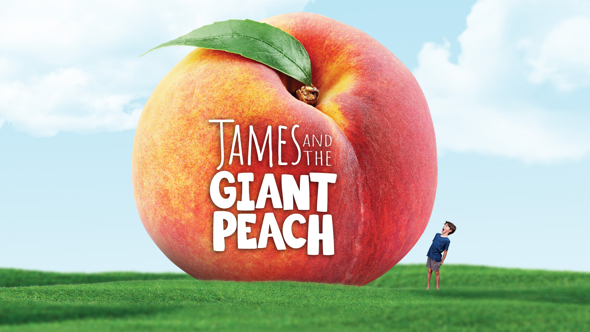 a boy marvels at a large peach