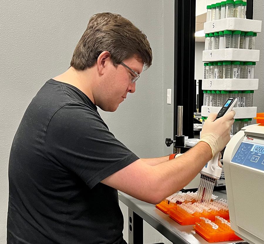 UAFS alum, Jordan Miesner-Davis, works with a multi channel pipette.