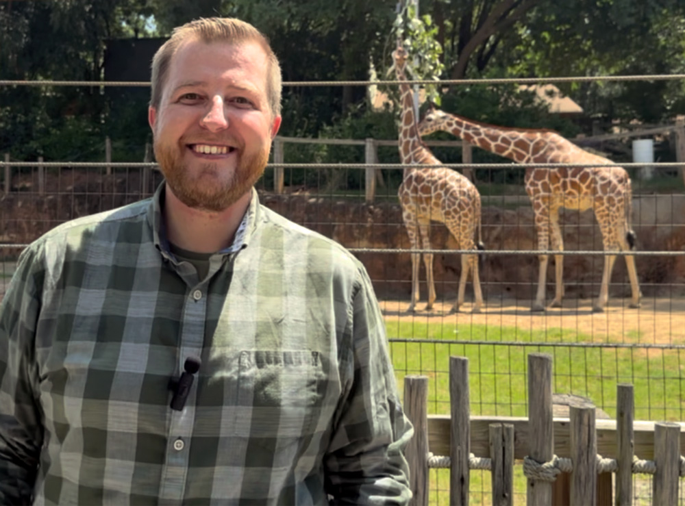 Josiah Olmstead poses with a pair of giraffes at Zoo Atlanta during the filming of his documentary, "My Grandfather: The Zookeeper."