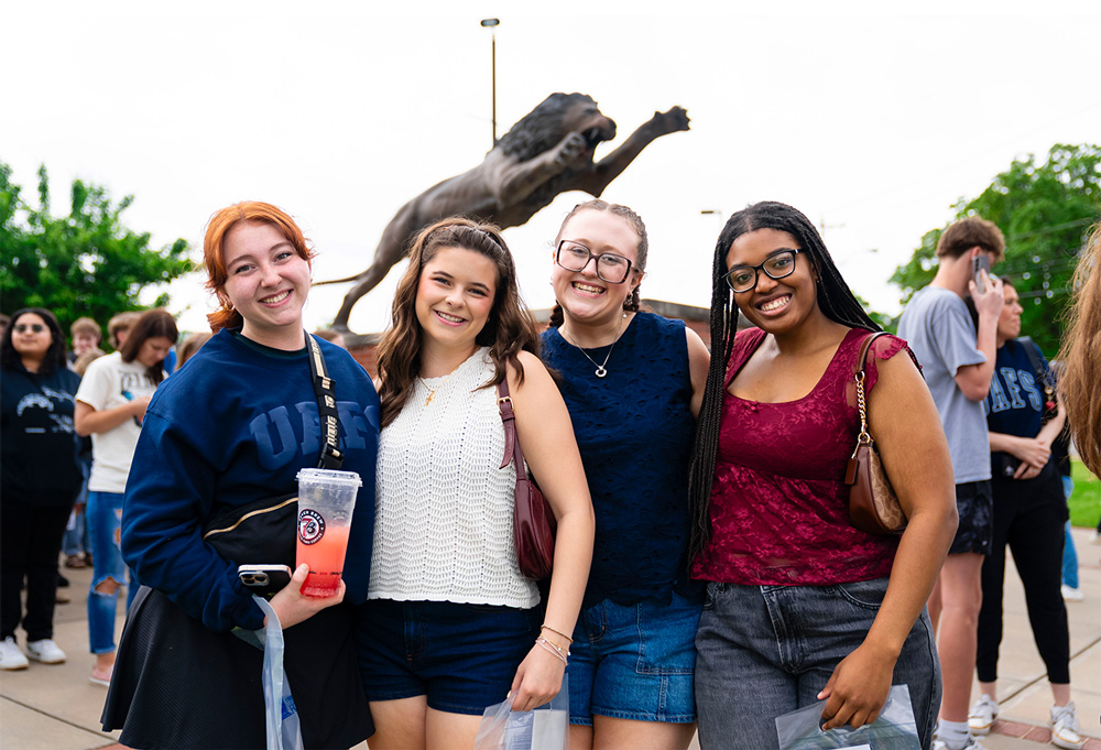 A group of incoming students share a smile outside of the Stubblefield Center at UAFS