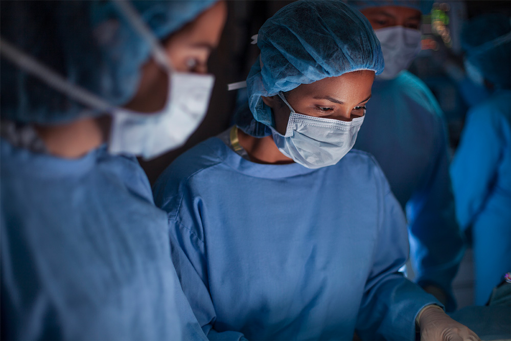An image of nurses in blue scrubs working