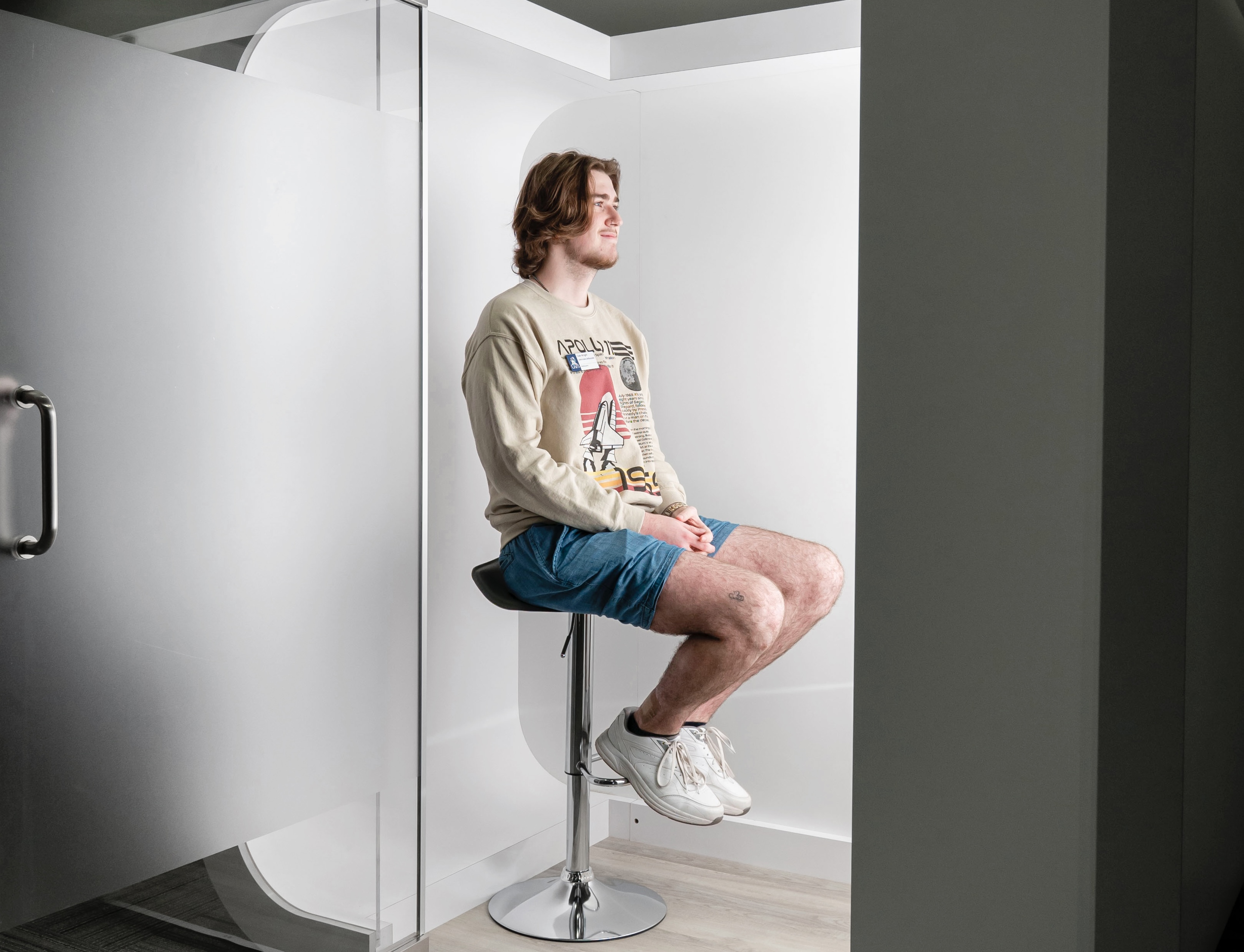 A student sits in the Iris Photo Booth