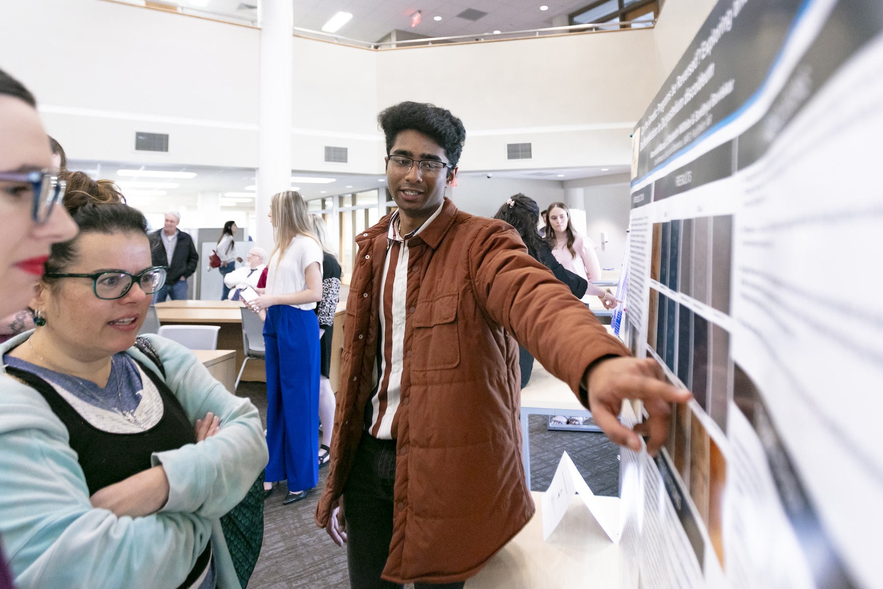 a student demonstrates his research during the 2023 symposium