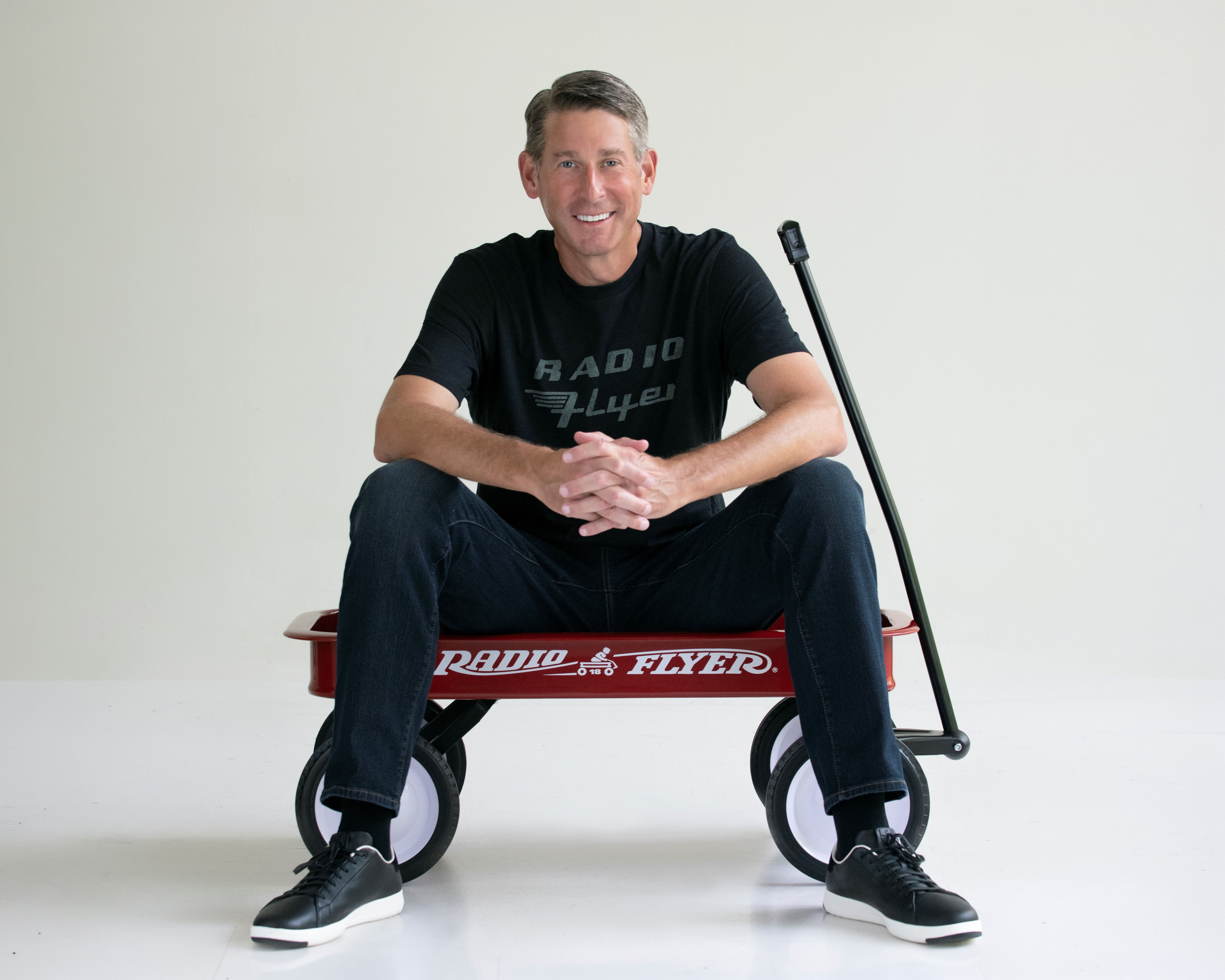 Robert sits for a portrait in a Little Red Wagon
