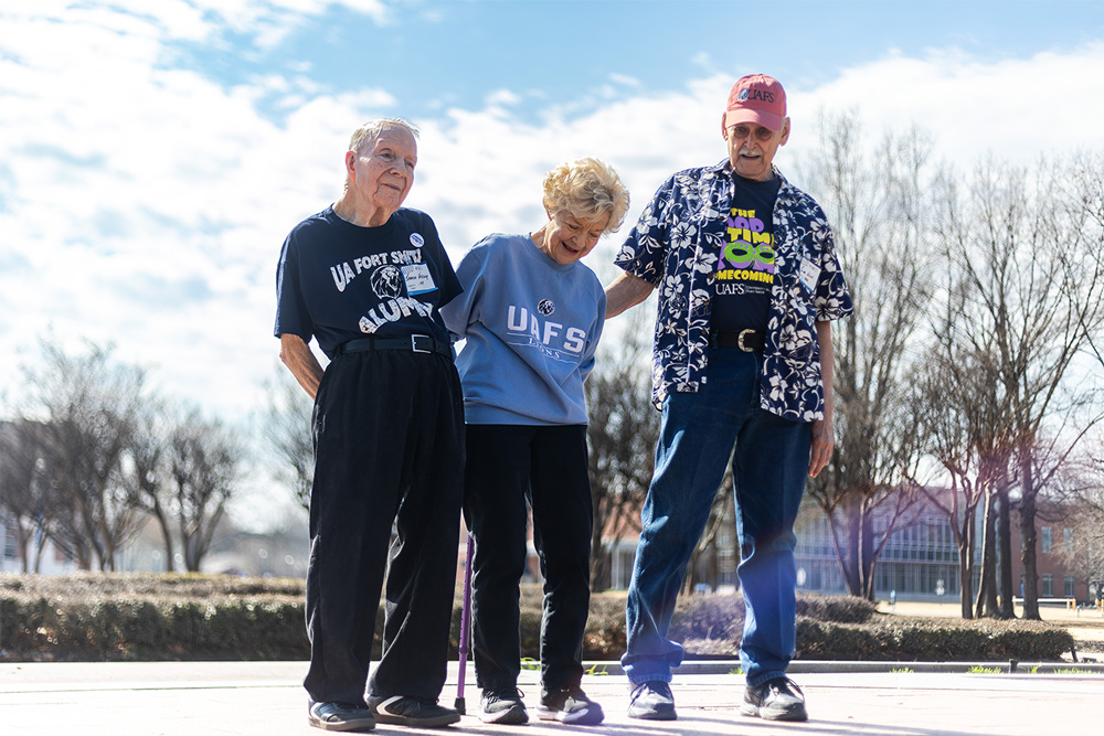 Sharon Winn (center) views the commemorative brick purchased by her husband, Jim (right), that is in Lion Pride Square.