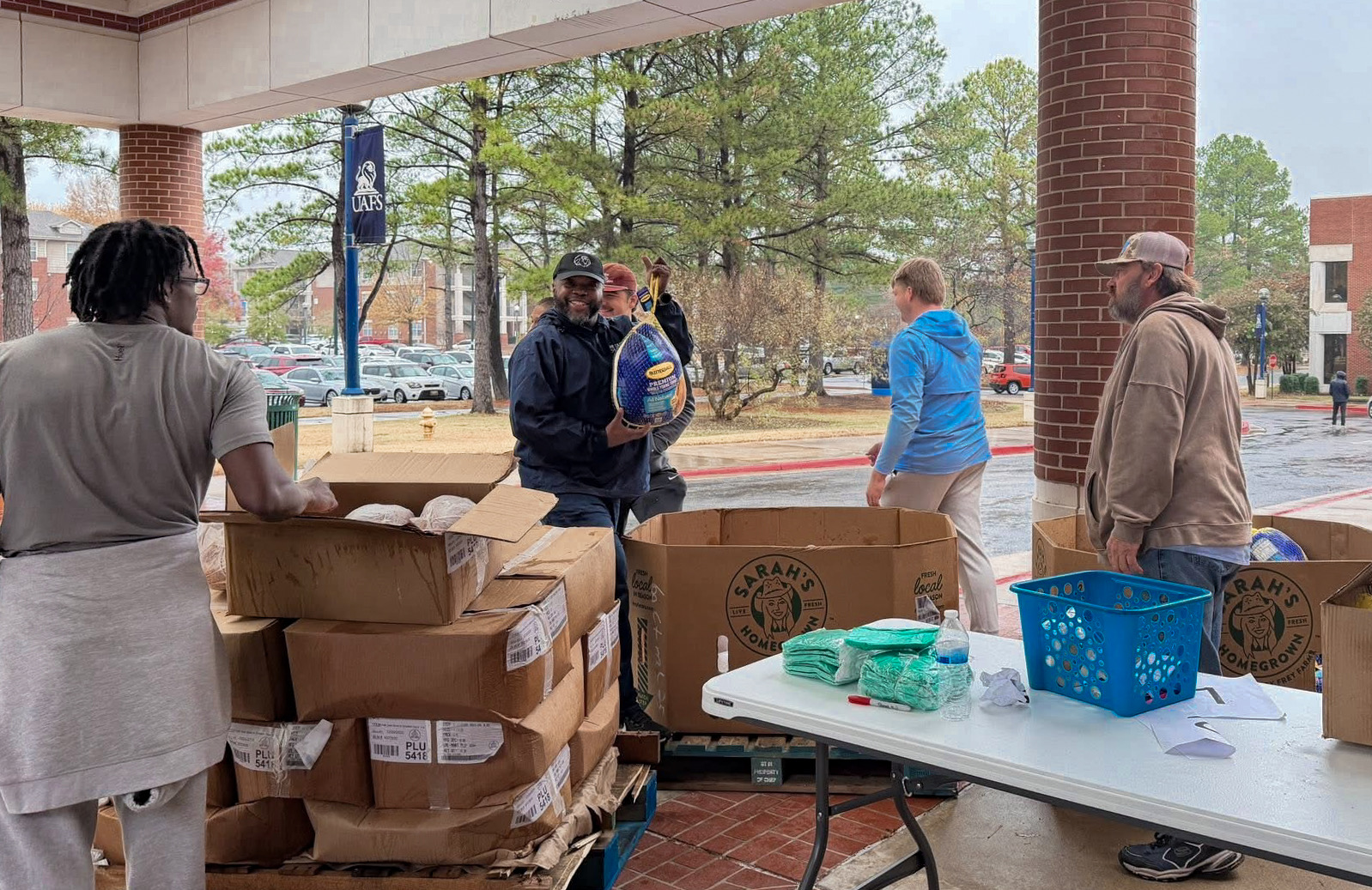 UAFS staff and students give away thanksgiving meals under the Campus Center portico