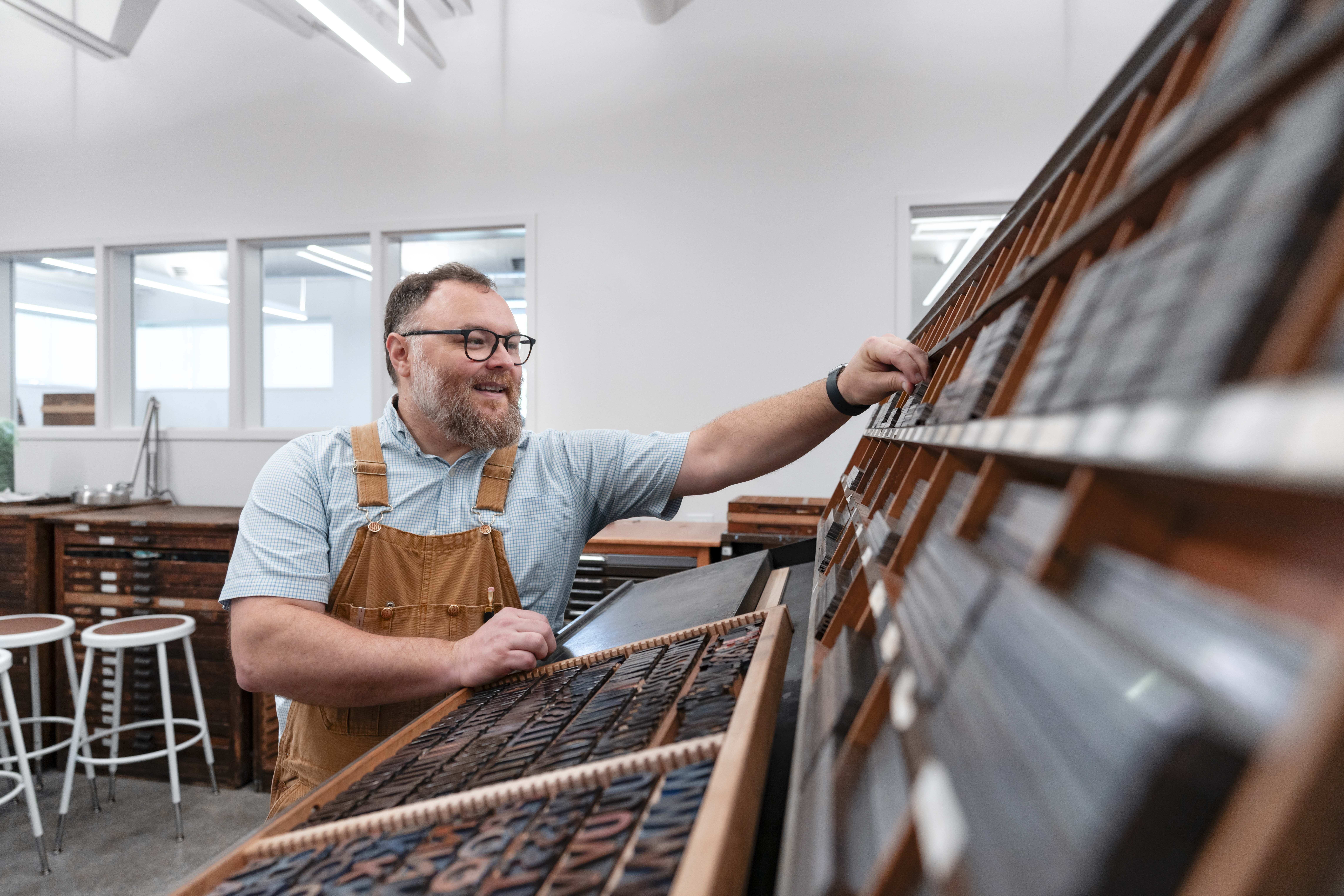 Jay Fox loads a letter tray in the new Center for Book Arts