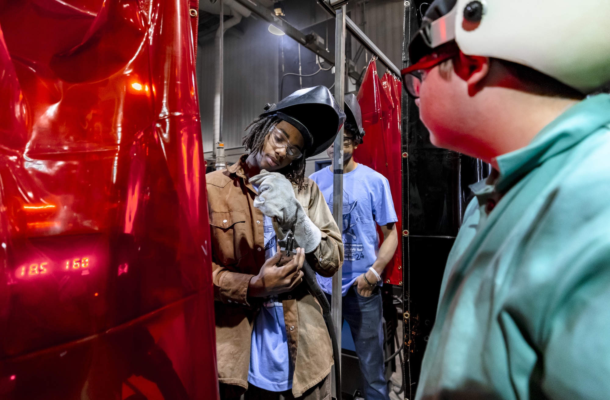 a UAFS student inspects a weld during the annual welding rodeo
